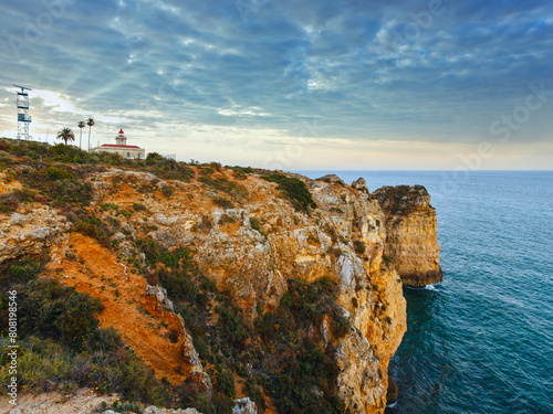 Evening view of lighthouse on cliff (Ponta da Piedade headland, Lagos, Algarve, Portugal).