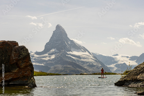 Paddle boarding in the tranquil waters before the majestic Matterhorn photo