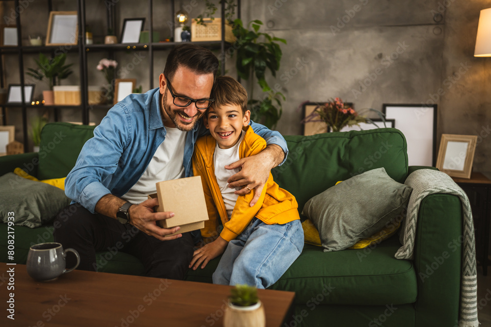 Son give gift his father and surprise him for birthday or fathers day Son give gift his father and surprise him for birthday or fathers day