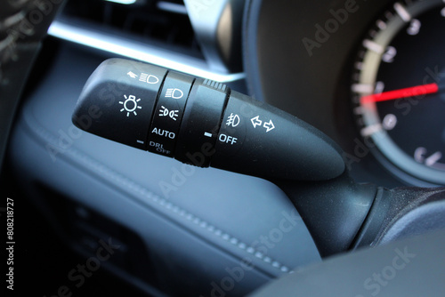 Close up of light control in car. Car light switch. Car interior with light switch. The light knob in the car. Multifunction Headlight Console Control Switch knob.