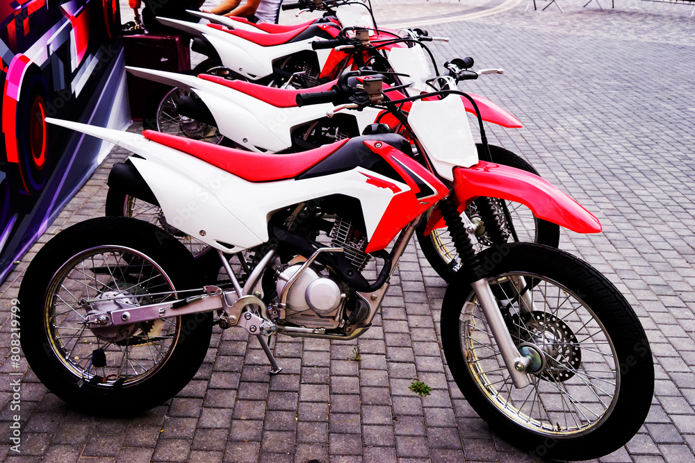 Fototapeta premium red and white racing motorcycles in the parking lot in the park,