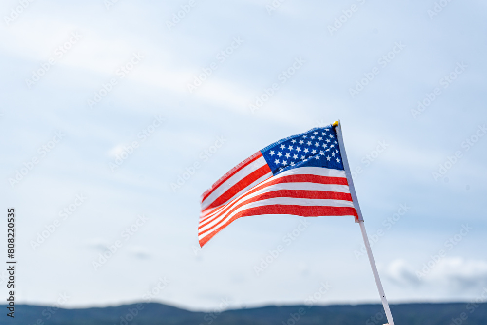 American flag waving against a clear blue sky American flag waving against a clear blue sky