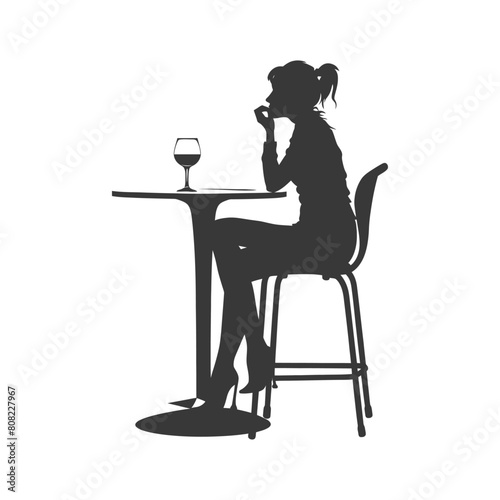 Silhouette woman sitting at a table in the cafe bar restaurant black color only