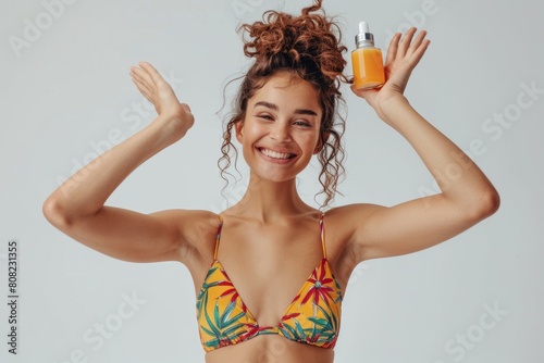 Young woman in a colorful bikini, holding a skincare product, joyful and carefree, celebrating beauty, on a light background