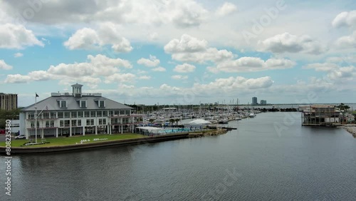 Wallpaper Mural panning aerial footage of the New Canal Lighthouse and the Southern Yacht Club with ocean water, green trees and grass, blue sky and clouds in New Orleans Louisiana USA Torontodigital.ca