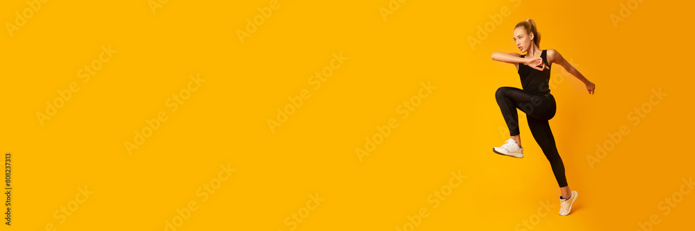 Cardio Workout. Slim Woman Jumping Exercising On Yellow Background In Studio. Sport And Fitness, Web-banner, Copy Space