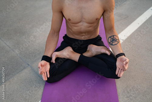 attractive hansome man with athletic strong body doing morning yoga dzen meditation photo