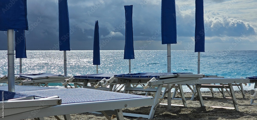 Naklejka premium Spotorno, Ligurian Riviera in summer. A bathing establishment is a tourist facility located near a beach, equipped with rooms and equipment that offer services and hospitality to bathers for bathing.