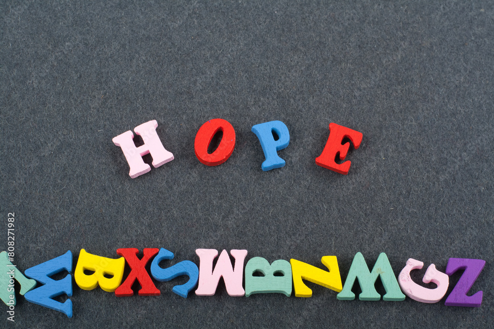 HOPE word on black board background composed from colorful abc alphabet block wooden letters, copy space for ad text. Learning english concept. HOPE word on black board background composed from colorful abc alphabet block wooden letters, copy space for ad text. Learning english concept.