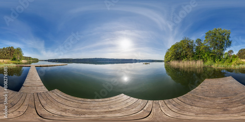 Fotografie full seamless spherical hdri 360 panorama on wooden pier of lake or river in mor