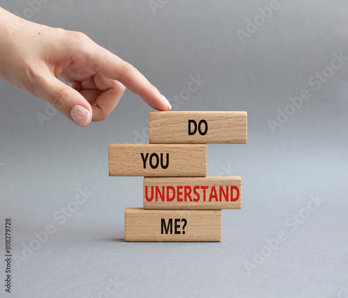 Do you understand me symbol. Concept words Do you understand me on wooden blocks. Beautiful grey background. Businessman hand. Business and Do you understand me concept. Copy space.