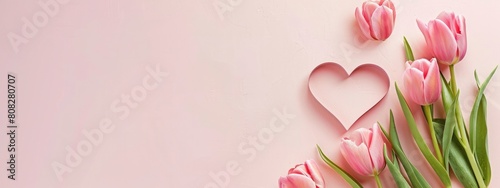 heart shaped cutout with pink tulips on a corner of light pink background #808280707