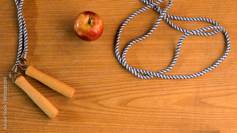 photography of apple next to skipping rope on color background, sports background, healthy living, exercise photography of apple next to skipping rope on color background, sports background, healthy living, exercise