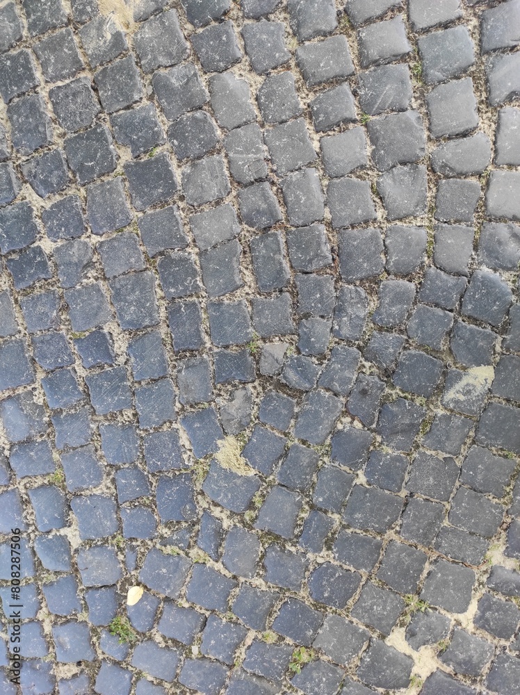 Cobblestone texture. Gray paving stones outside close-up. Design blank Cobblestone texture. Gray paving stones outside close-up. Design blank