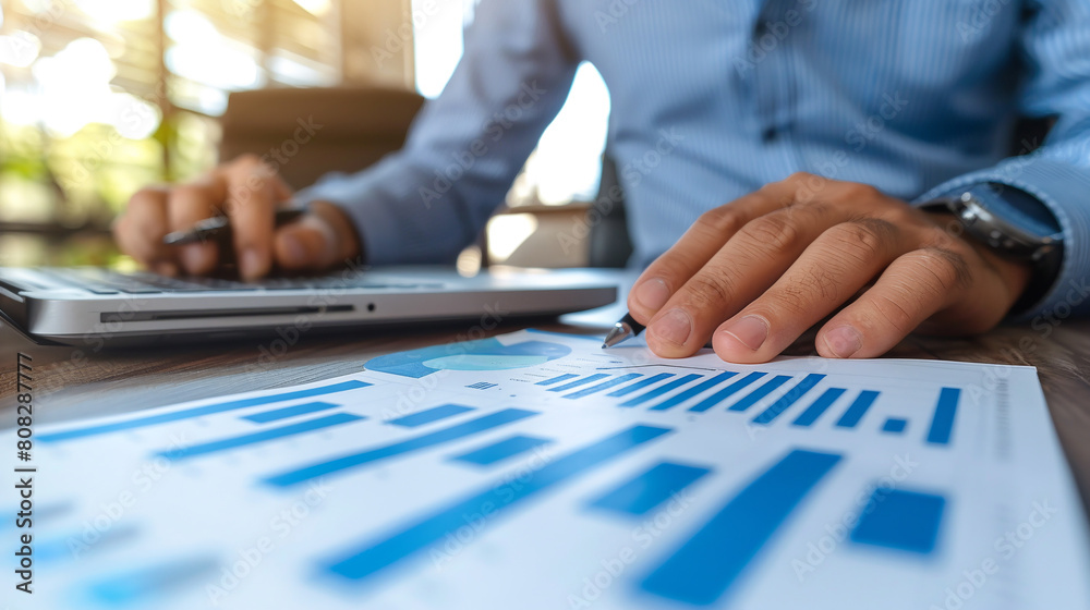 Businessman analyzing investment charts with laptop. AI. Businessman analyzing investment charts with laptop. AI.