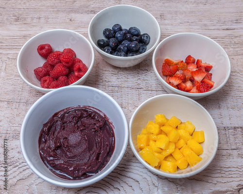 Acai bowl with mango, strawberries, blueberries and raspberries