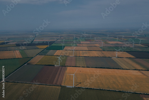 Wind power plant on a green field. Clean energy future. Photography from above. Energy in Ukraine. © Denis Chubchenko