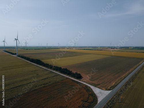 Wind power plant on a green field. Clean energy future. Photography from above. Energy in Ukraine. © Denis Chubchenko