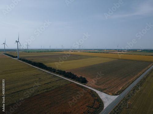 Wind power plant on a green field. Clean energy future. Photography from above. Energy in Ukraine.