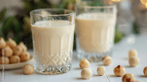 Vegan macadamia milk in glass on a white table