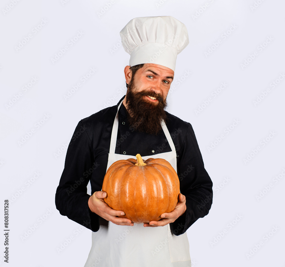Smiling male chef in white apron with pumpkin. Organic food. Harvest festival. Bearded man in chef uniform with pumpkin. Thanksgiving day cooking. Autumn recipes. Useful vegetables. Seasonal vitamin. Smiling male chef in white apron with pumpkin. Organic food. Harvest festival. Bearded man in chef uniform with pumpkin. Thanksgiving day cooking. Autumn recipes. Useful vegetables. Seasonal vitamin.