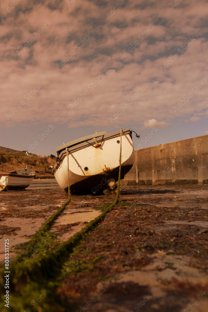 Fishing boats moored, at low tide, at Nefyn Port, Gwynedd, North Wales. Taken in evening sunlight. Fishing boats moored, at low tide, at Nefyn Port, Gwynedd, North Wales. Taken in evening sunlight.