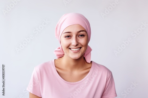 Wallpaper Mural Optimistic young woman with cancer wearing headscarf on white background. Girl after chemotherapy treatment. Oncology patient battling with tumor. World cancer day. Healthcare and medical concept Torontodigital.ca