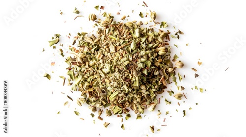 A top view of dried oregano scattered loosely, showcasing the small, crumbled pieces and their earthy color on a white background