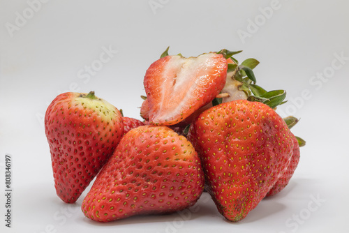 Canvas Print Strawberries cut whole on a whim background juice vibrant