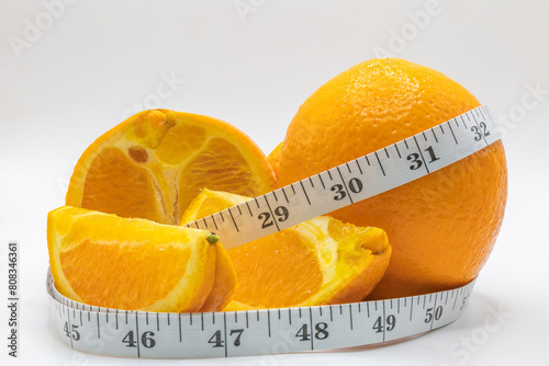 Orange measuring tape orange slices on an white background isolated on white 