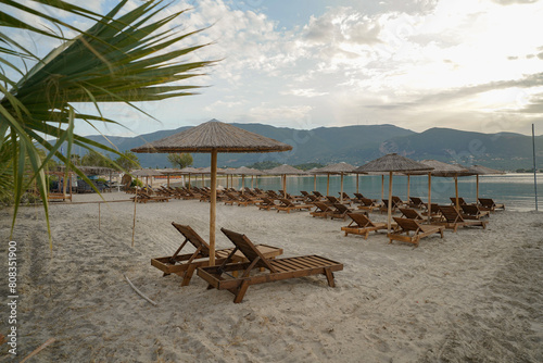 wooden sun beds and parasols on Alikanas beach photo