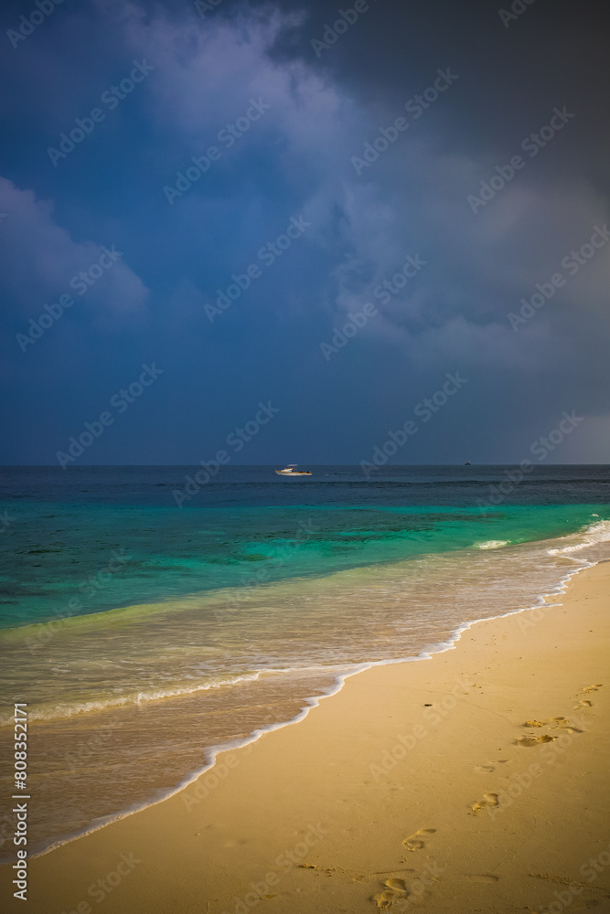 beautiful exotic tropical beach and stormy clouds