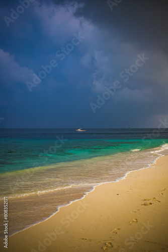 beautiful exotic tropical beach and stormy clouds