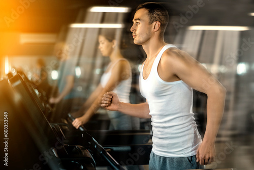 Man walk on treadmill in gym. Active hobby, healthy lifestyle, extensive training