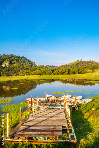 Lake with dock and boats in arcos del sitio in tepotzotlan state of mexico  photo