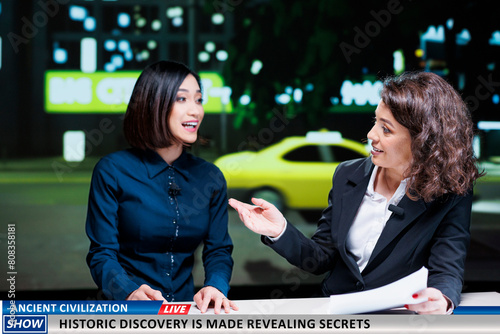 Show hosts reveal historic discovery made by specialists and experts, finding ancient civilization remains. Newscasters team debating historical disclosure on international tv program.