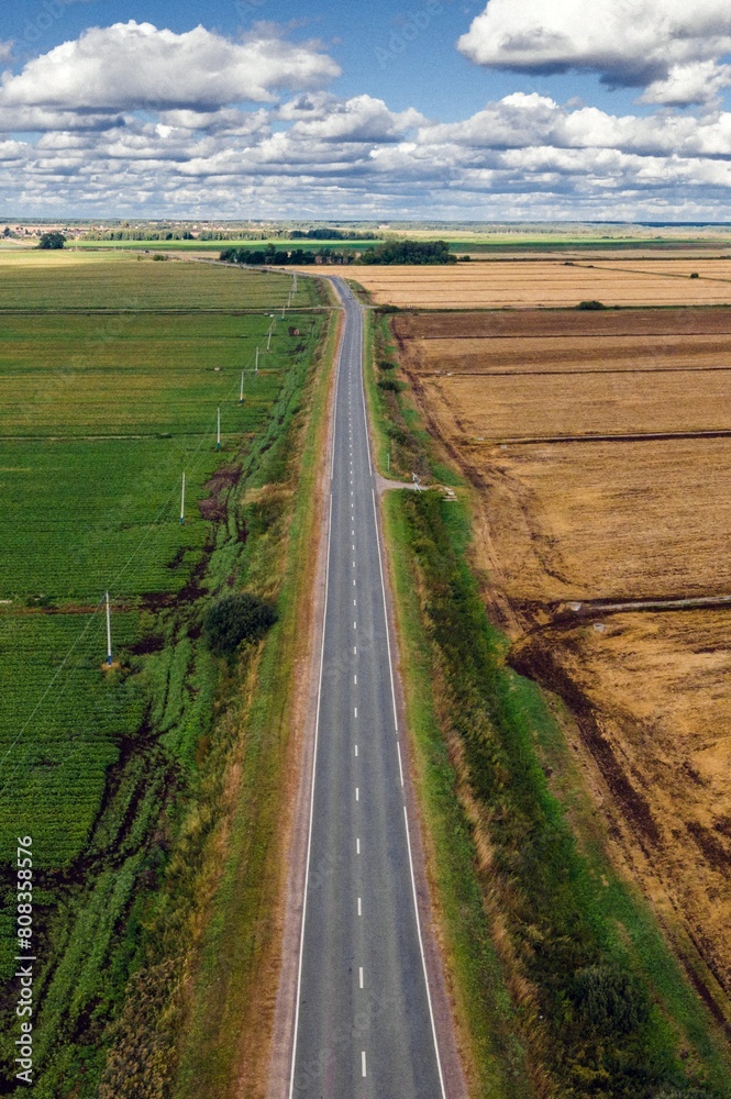 Highway Through the Heartland: 4K Ultra HD image of Aerial View Over Multi-Lane Highway Amidst Agricultural Fields