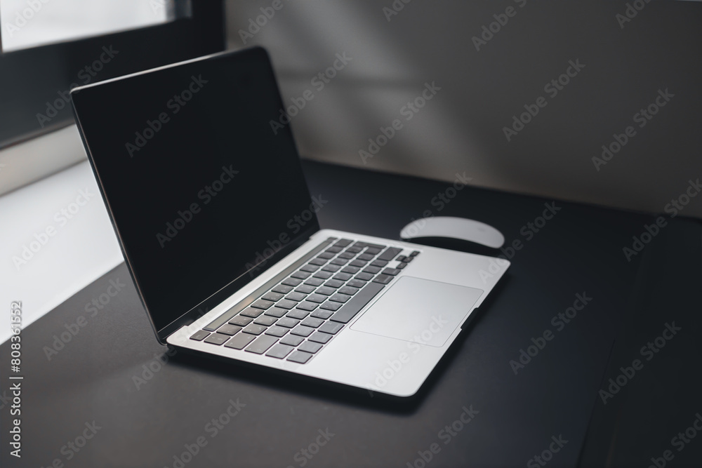 a laptop on table near window a laptop on table near window