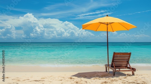 A chair and an umbrella provide shade on the sandy beach  with the azure sky reflecting in the crystal clear water of the oceanic coastal landforms AIG50