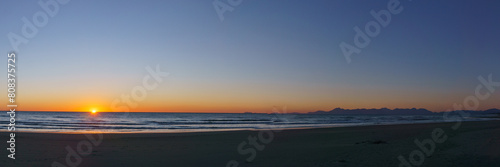 Panoramic view of sandy sea beach with Amalfi Coast in the background during evening twilight after sunset  Paestum  Campania  Italy