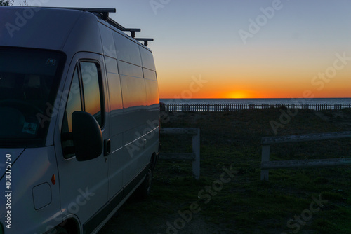 Camper van on the mediterranean coast during sunset at beach in Calabria, Italy