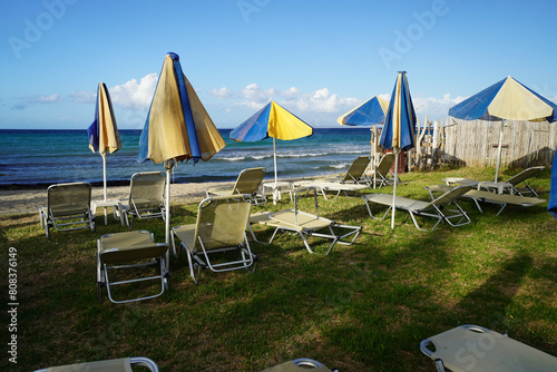 sun beds and beach umbrellas in Argassi beach in Zakinthos , Greece