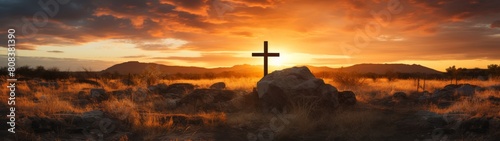 dramatic sunset over desert landscape with cross photo