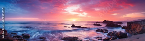 Vibrant sunset over rocky coastline photo