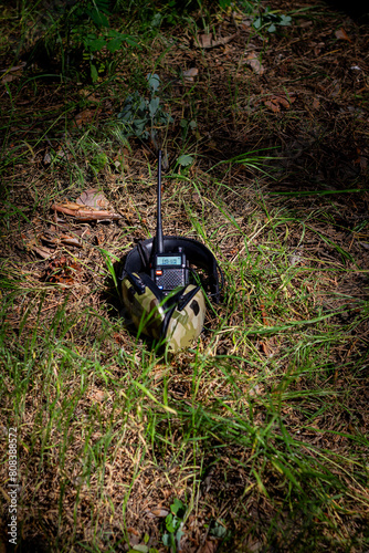 Wallpaper Mural Military equipment, tactical headphones and a walkie-talkie in the forest on the ground. Military actions, war in Ukraine Torontodigital.ca