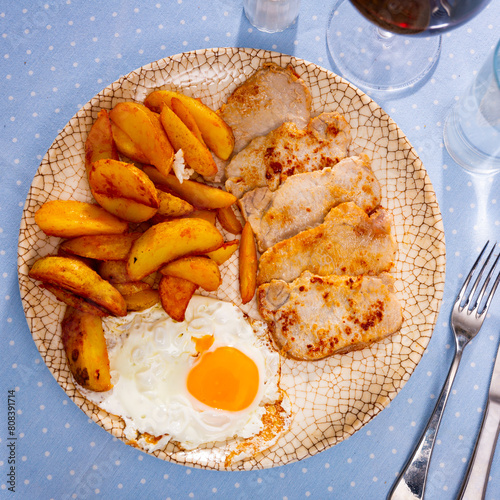 Plate with prepared food pork chop with potatoes and fried egg © JackF
