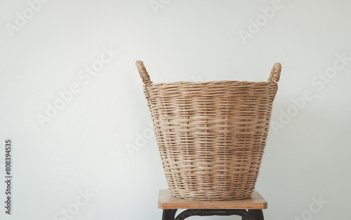 Empty wooden wicker basket isolated on white background. Vintage hamper basket laundry clothes.
