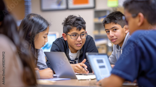 The student is working on a group project with their classmates. They are all working together and are helping each other. The student is a good team player and enjoys working with others.