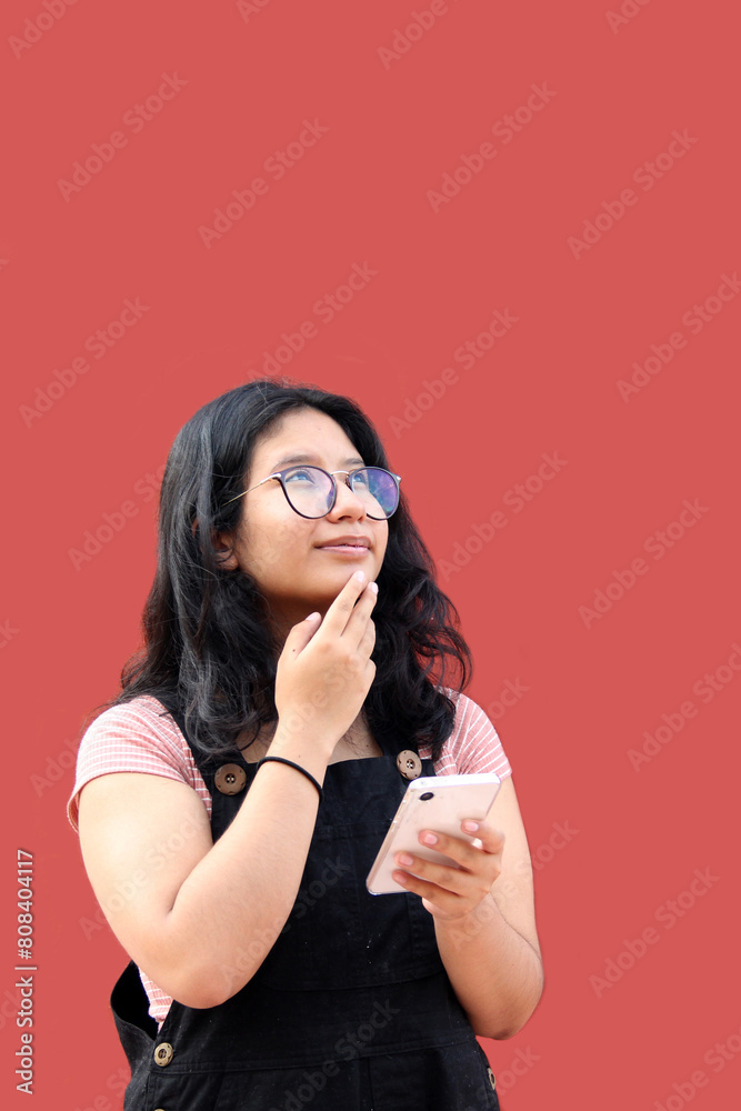 17-year-old Latina teenage woman uses her cell phone to send messages, do homework, buy, pay and take advantage of discounts and promotions 17-year-old Latina teenage woman uses her cell phone to send messages, do homework, buy, pay and take advantage of discounts and promotions