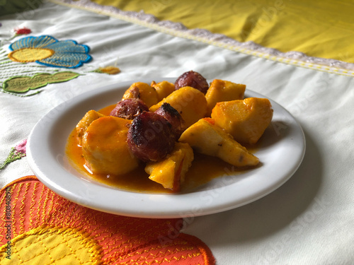 medium-cooked yam with Calabrian sausage sauce on a white porcelain plate photo